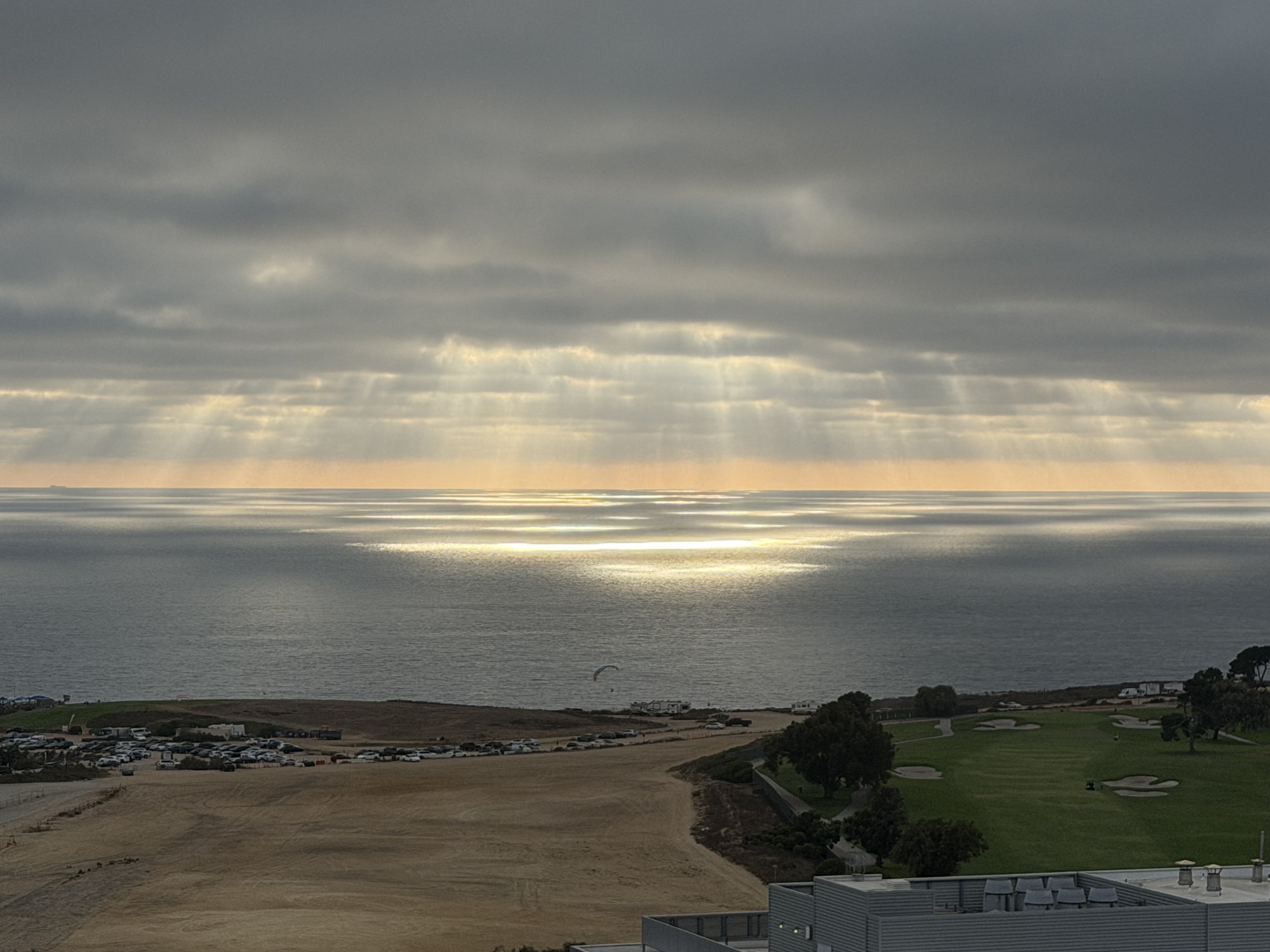 Sunbeams breaking through clouds above the San Diego coast